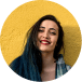 Smiling person with dark hair against a bright yellow background.